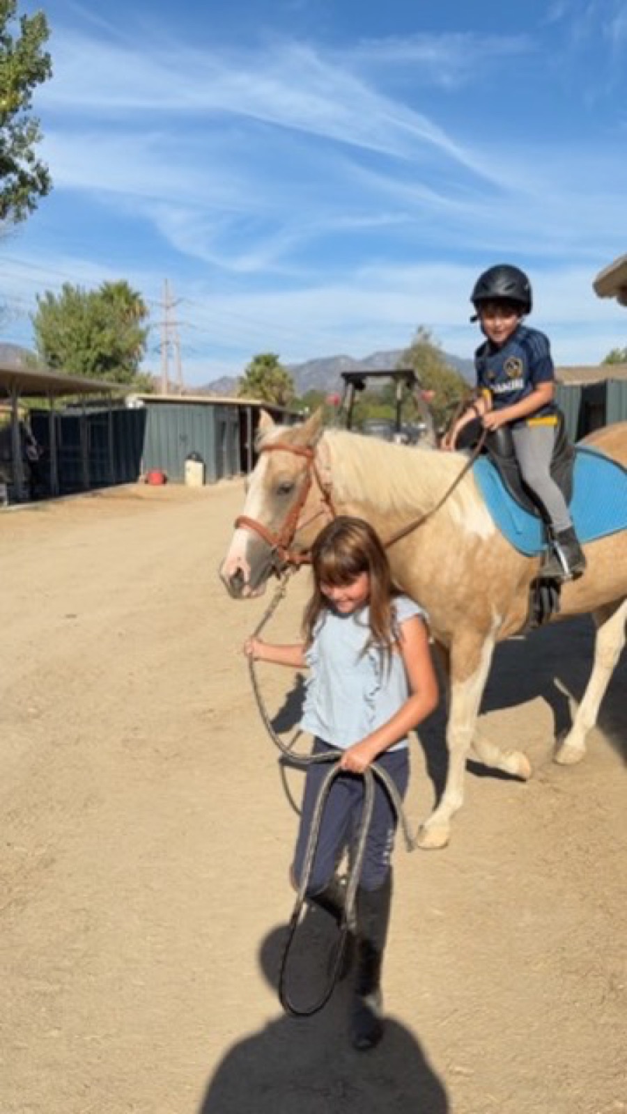 Kids grooming and leading horses at Hussar Stables